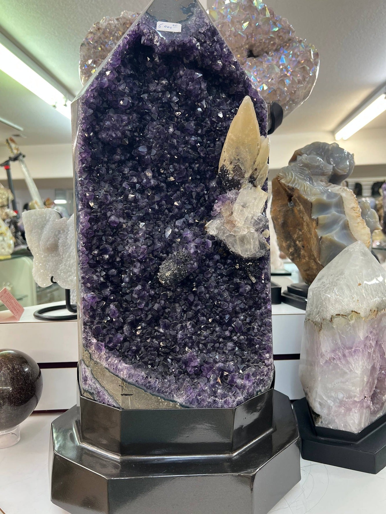 Amethyst cathedral with calcite on stand – view 1