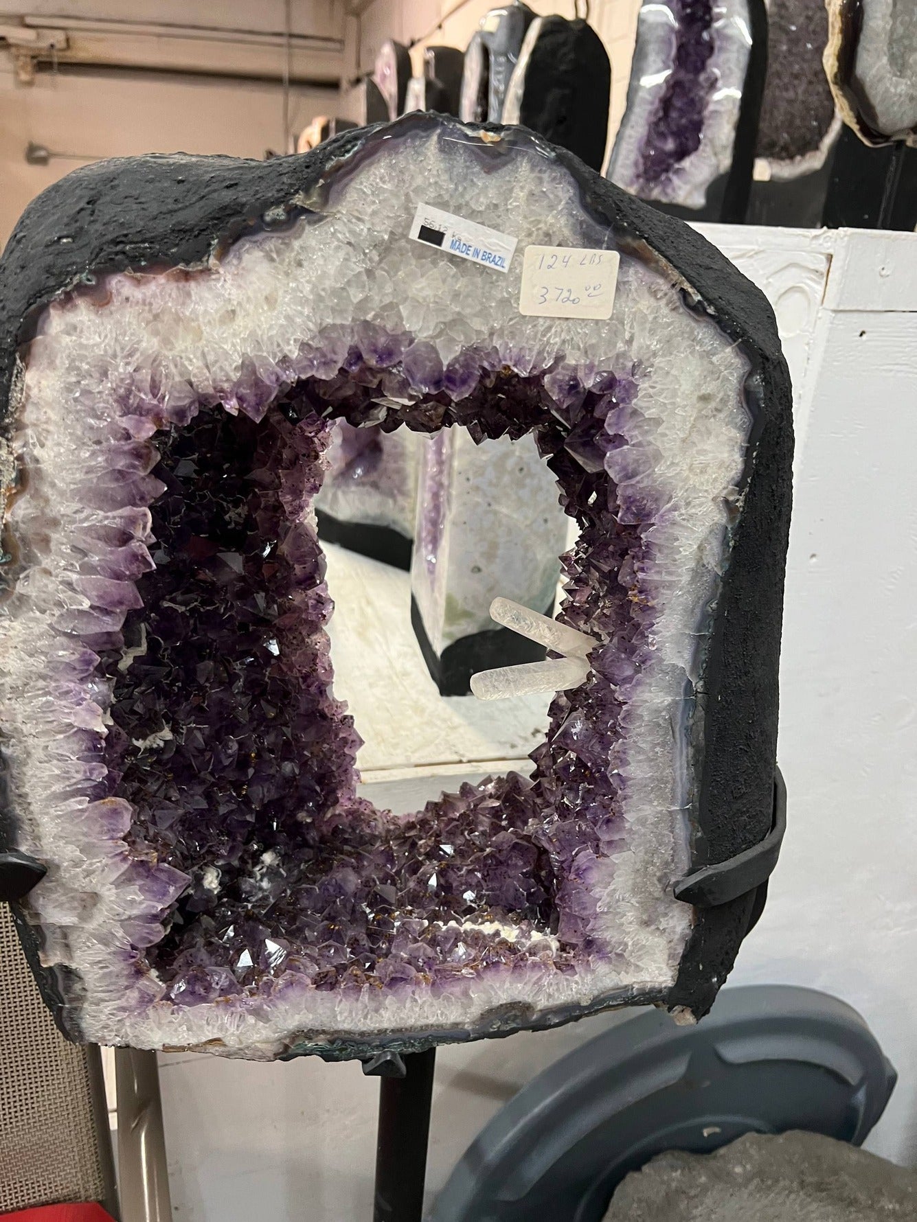 Beautiful Geode cut with clusters and points inside the amethyst tower on stand – Full front view