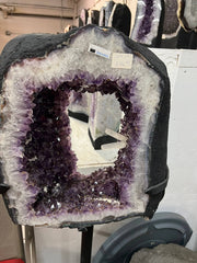 Beautiful Geode cut with clusters and points inside the amethyst tower on stand – Full front view