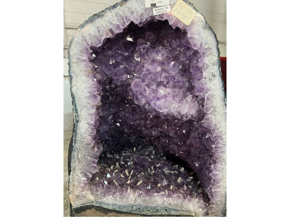 Brazilian amethyst geode with white calcite crystals — front view