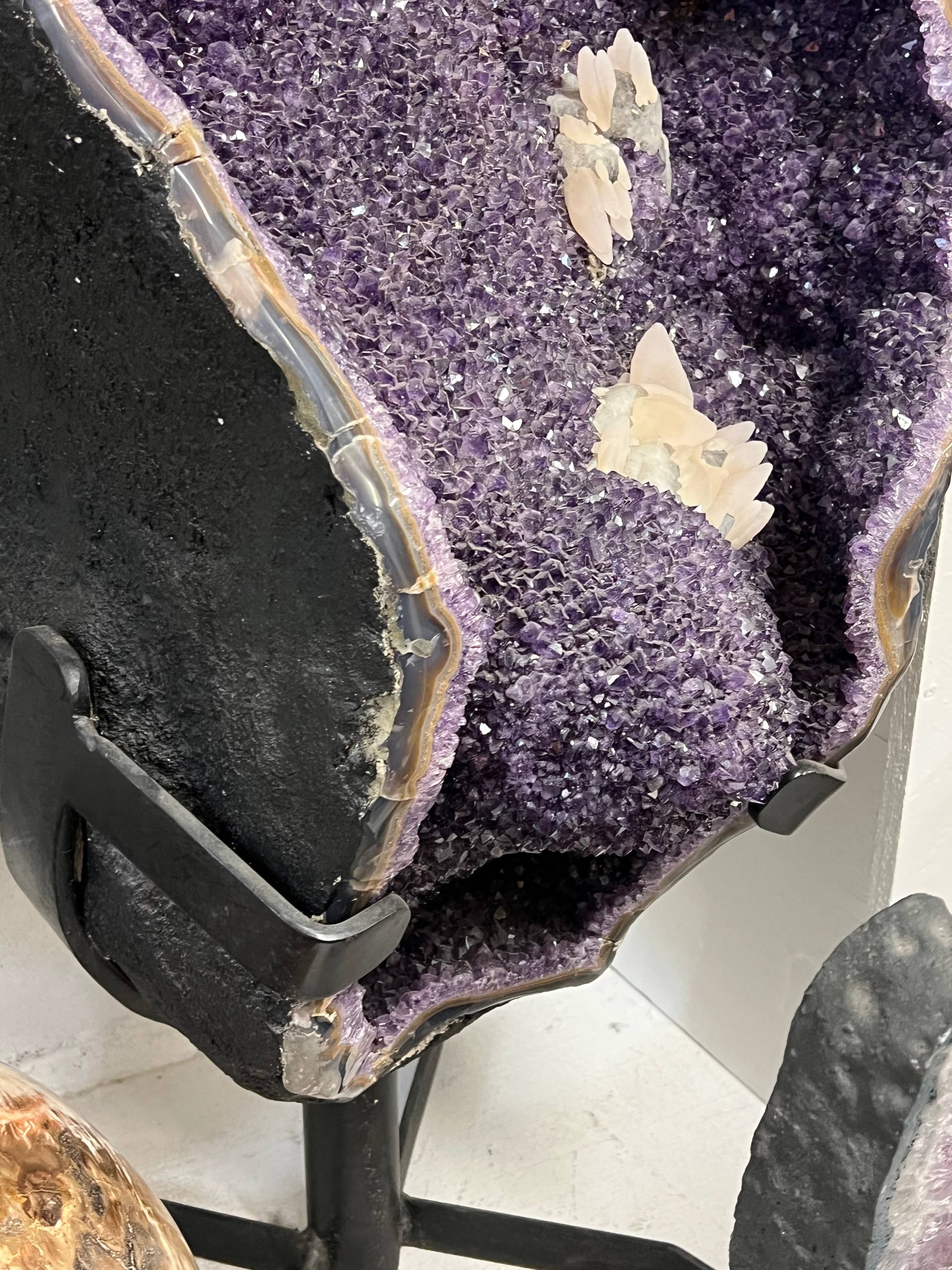 Large amethyst geode with calcite on stands – view 3