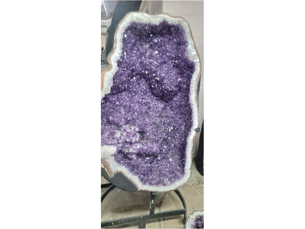 Giant amethyst geode cathedral on iron stand — front view