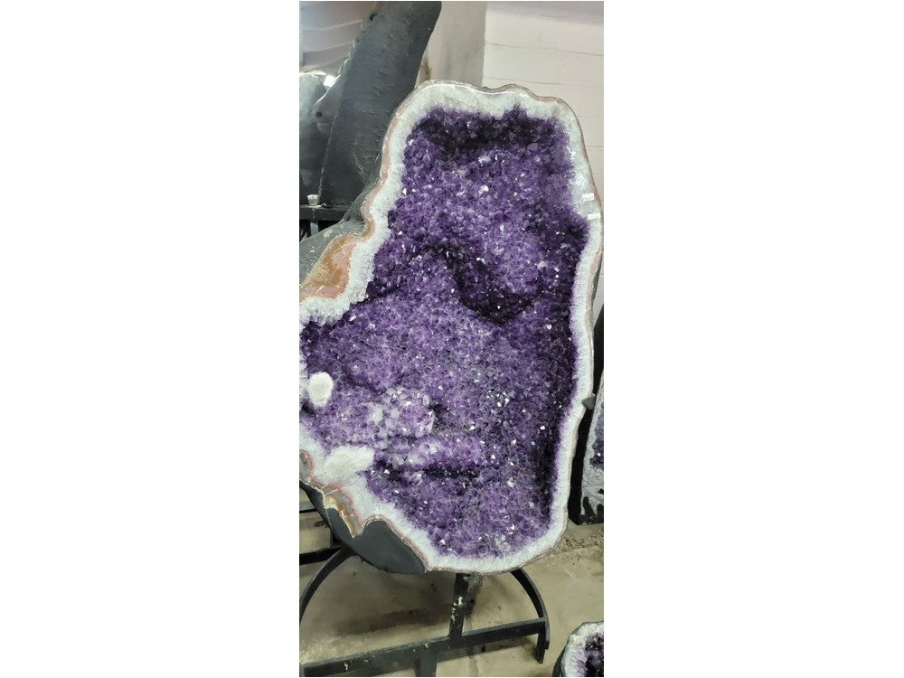 Large amethyst geode on display stand — full view