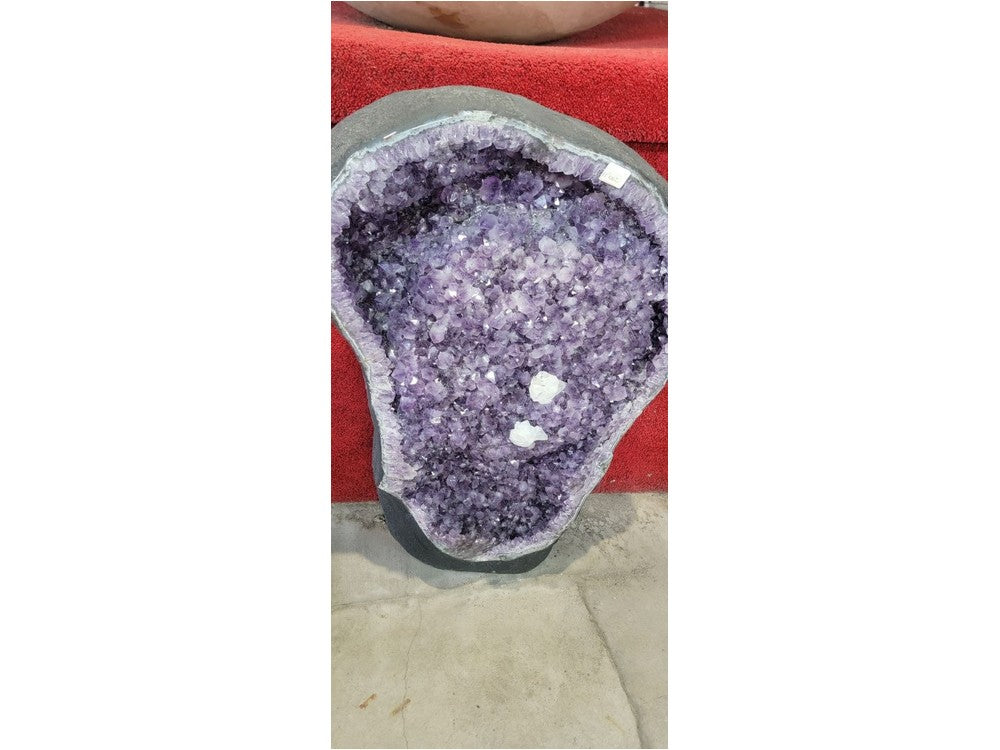 Amethyst geode interior close-up — violet crystals and calcite